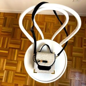 Faux sheepskin purse with black trim